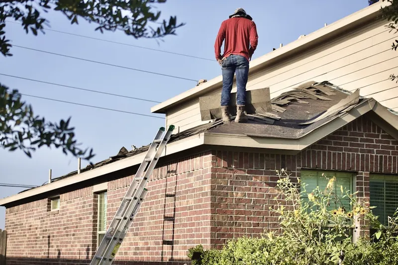 Professional roofer working on a residential roof in Belco